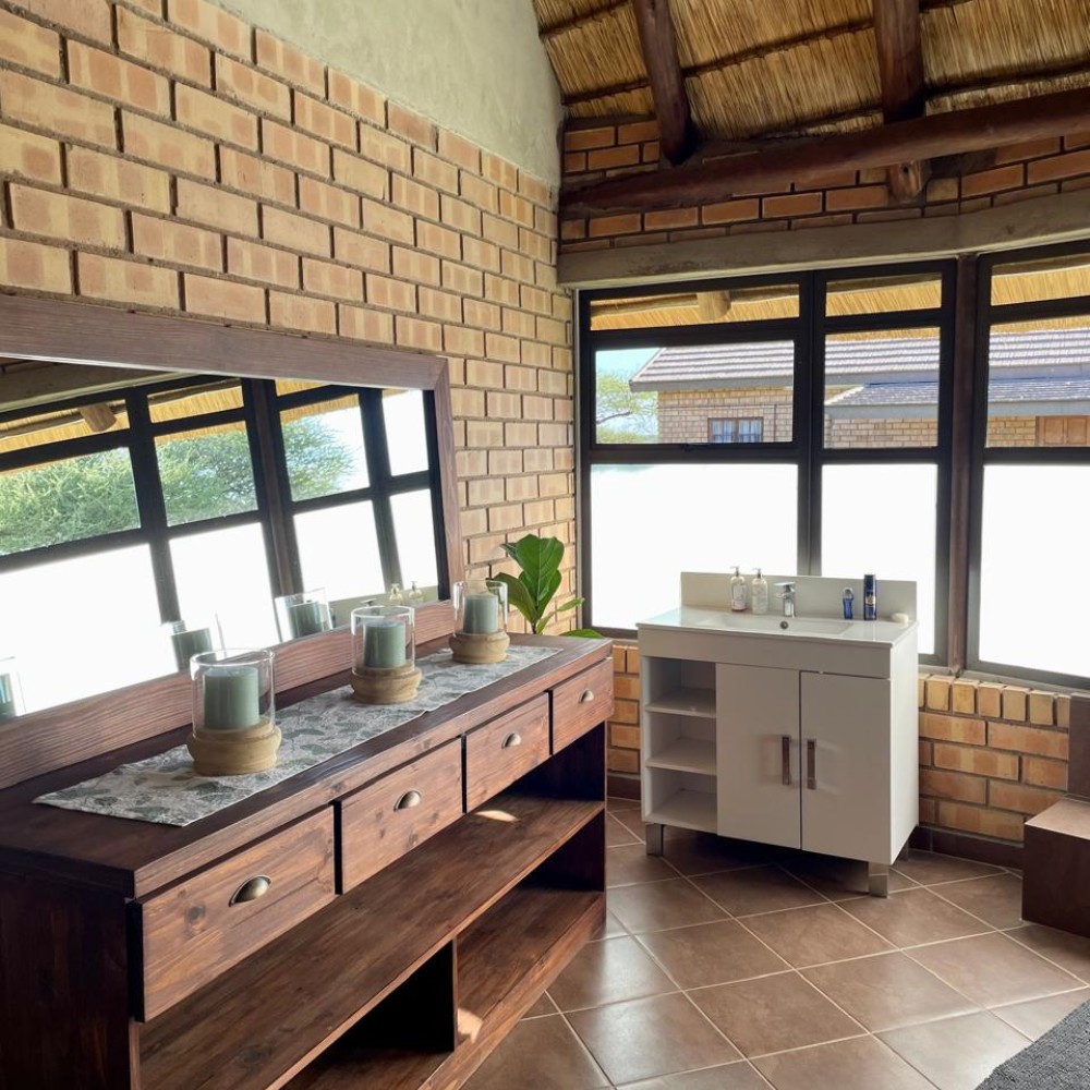 Lodge bathroom — brick walls and vanity