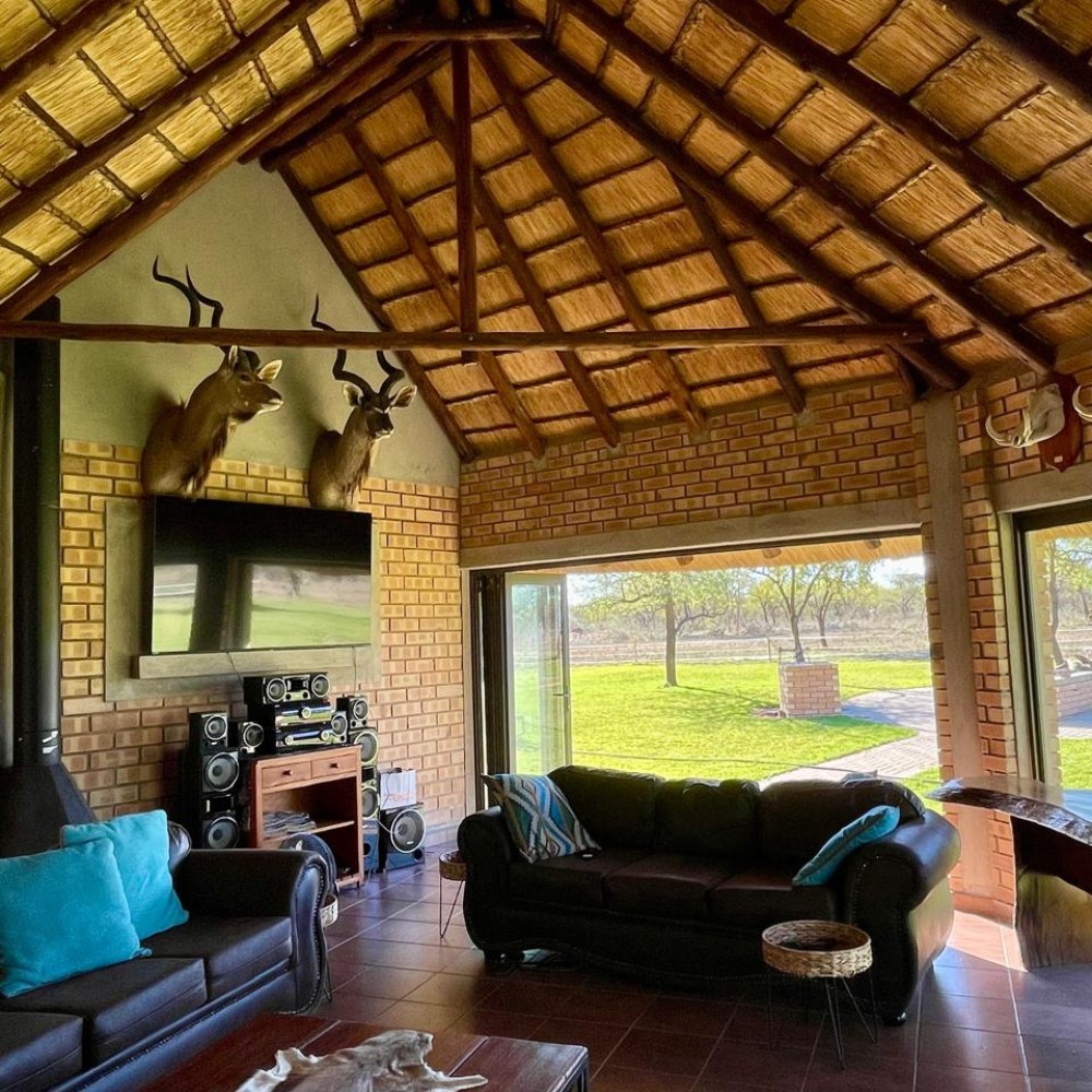 Lodge lounge — kudu mounts and thatched ceiling